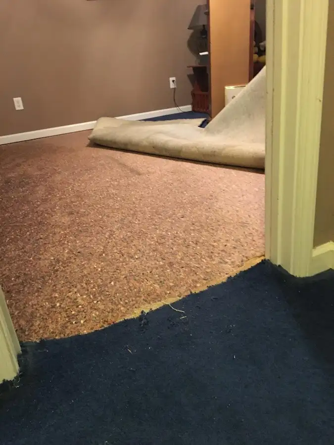 Carpet pad removal revealing water damage during Drying & Dehumidification in Fort Dodge